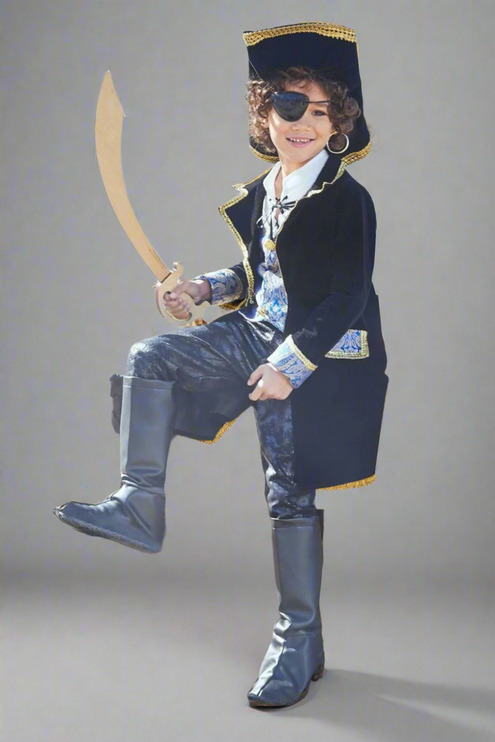Child in pirate costume with sword on a beach