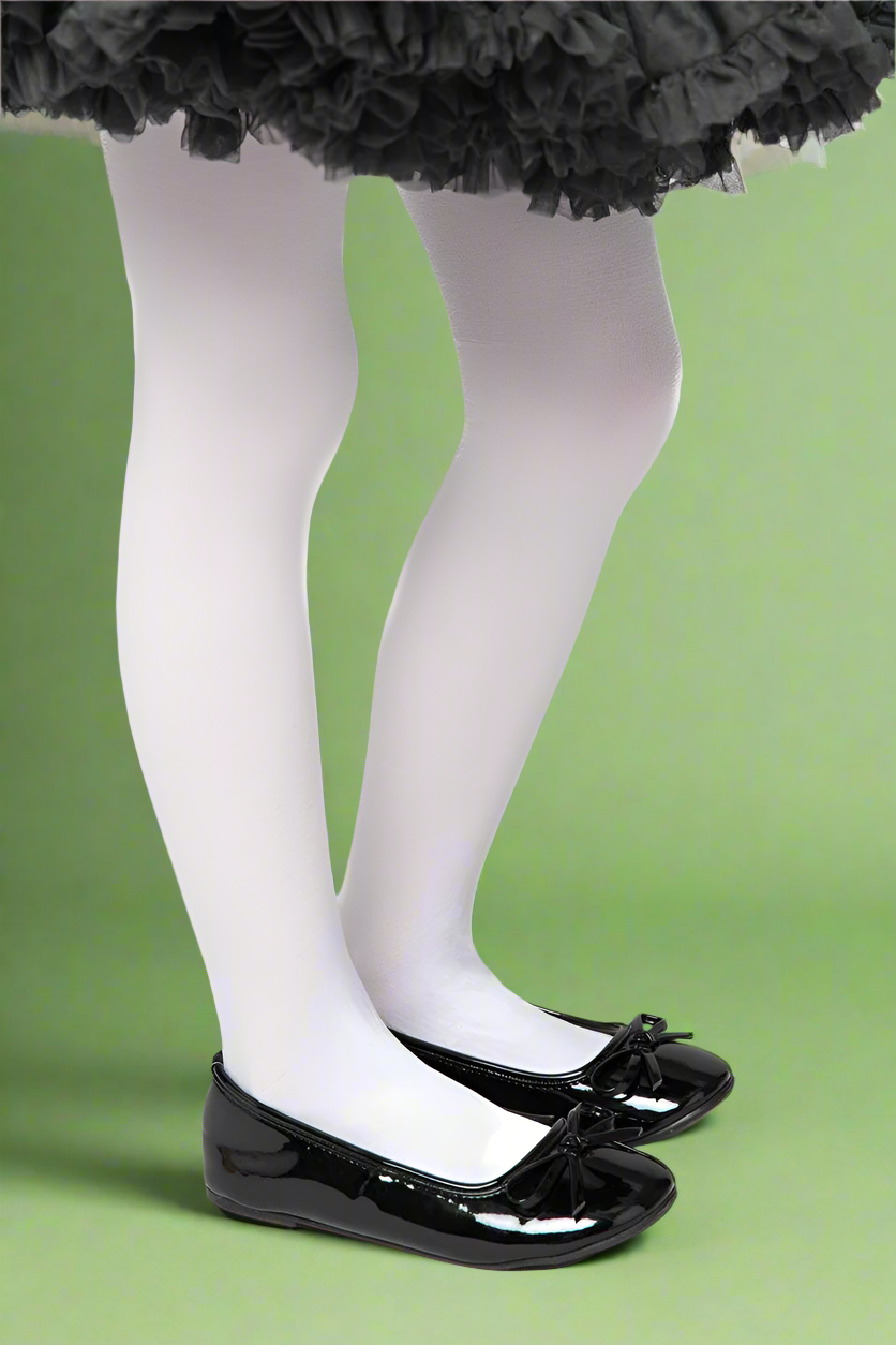 Person wearing a black tutu, white tights, and black shoes on a green background