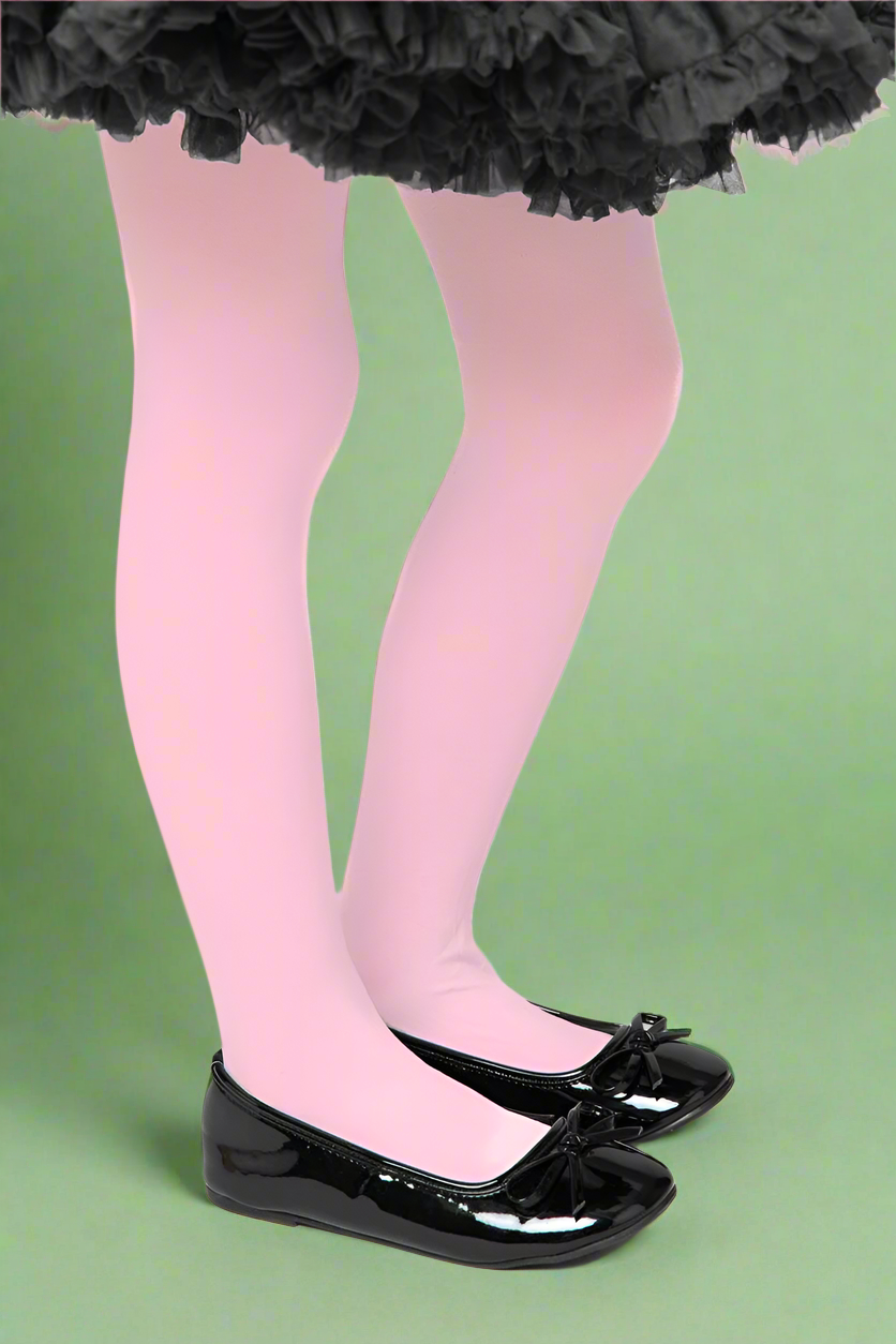 Pink tights worn with black shoes and a black tutu on a white background