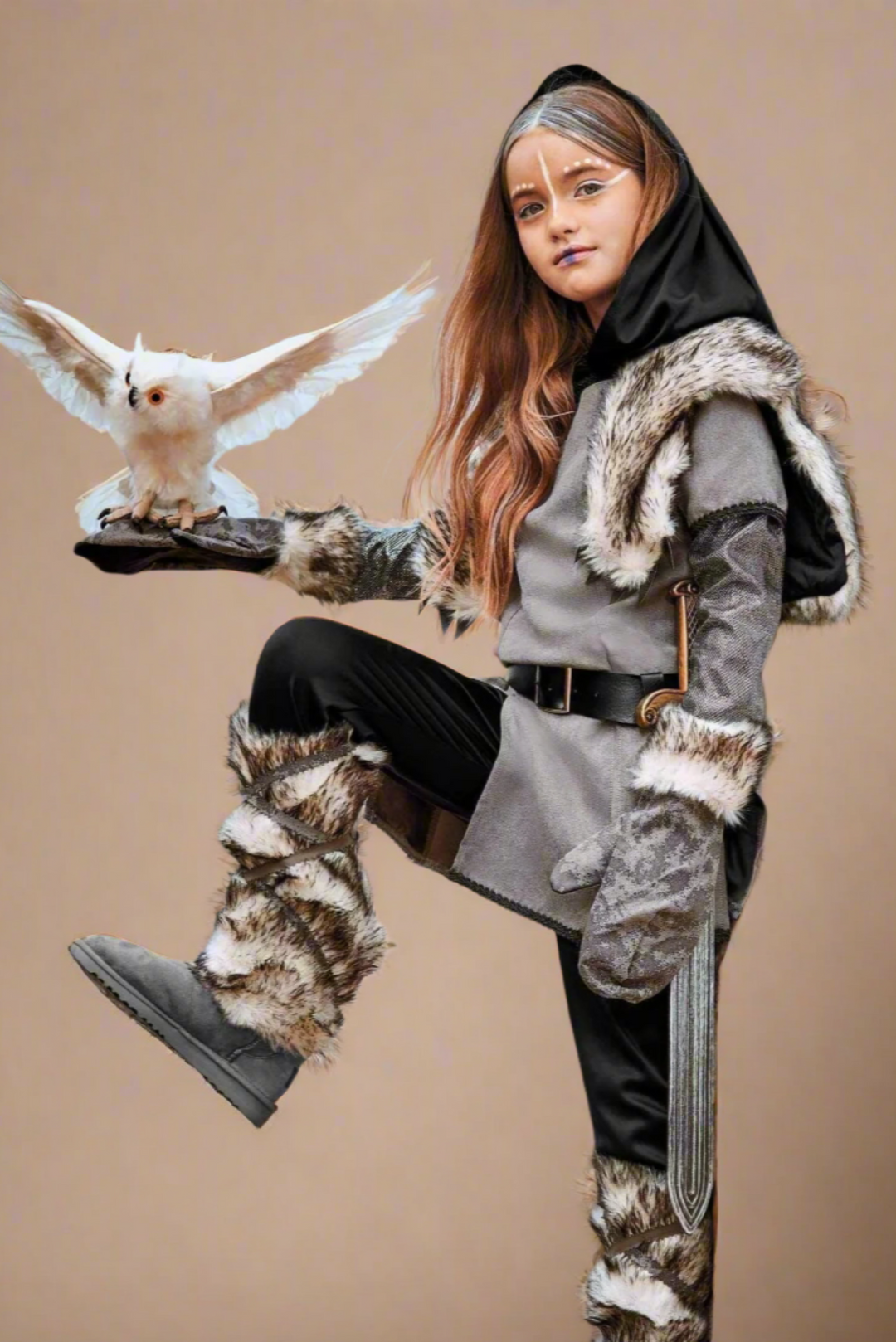 Person in fantasy-themed outfit with snowy owl on beige background